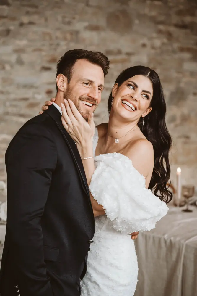 Gut Ostenwalde Hochzeit Brautpaar Braut grift am Hals und lacht